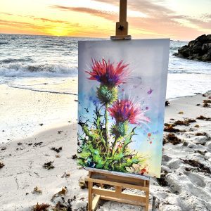 Scottish thistle canvas artwork displayed by the ocean at sunset