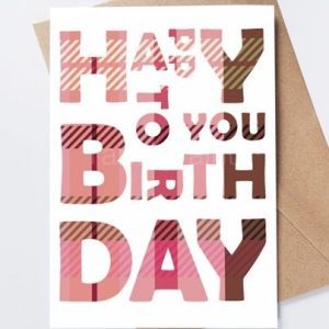 Pink tartan birthday card with bold white and dark pink block letters over a plaid pattern
