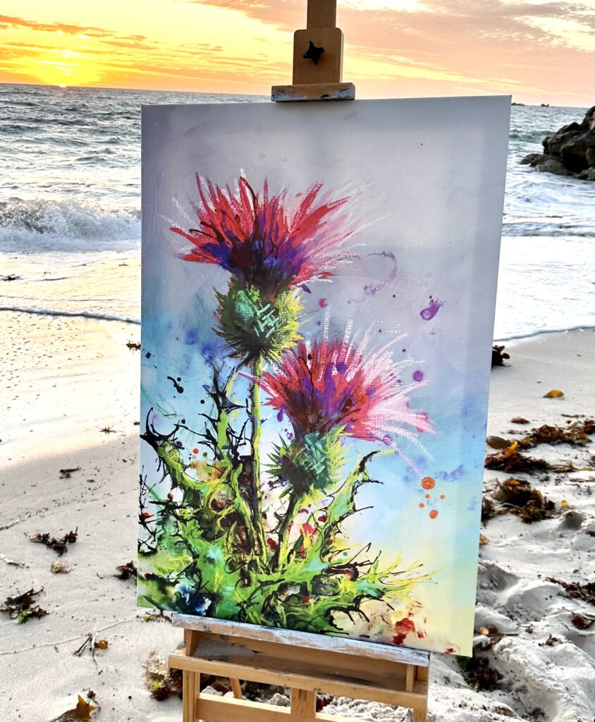 Original Scottish thistle canvas painting on an easel at sunset on a Perth beach