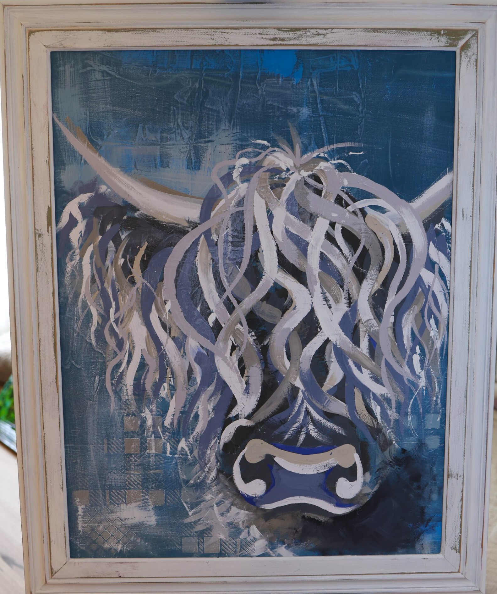 Bluebell, an original Highland cow painting in deep blue and grey with a distressed white frame, by Tartan Paint Perth