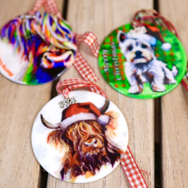 Scottish ceramic Christmas baubles, Highland cow and Scottie dog designs with tartan ribbon