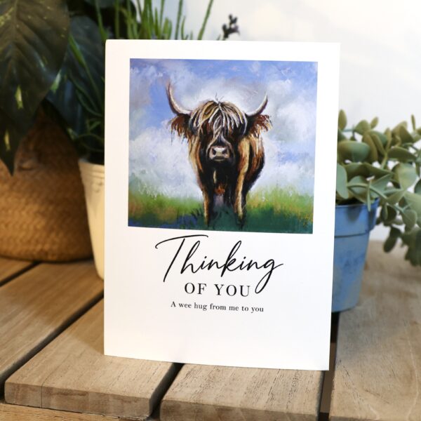 Thinking of You card, brown Highland cow in a green field under blue sky, A wee hug from me to you, Tartan Paint card