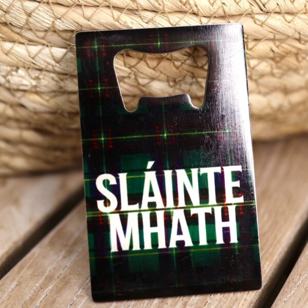 Slainte Mhath credit card bottle opener on dark green tartan